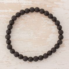 Circling the wrist with the dark hues of the earth this stretch bracelet features beads of black onyx and lava stone that alternate. Lorena Cofino of Guatemala designs the bracelet using stone to transmit wisdom of one's ancestors. Casual Black Beaded Bracelets With Natural Stones, Black Beaded Stretch Bracelet For Meditation, Black Hand-strung Stretch Bracelet For Meditation, Black Natural Stones Stretch Bracelet For Healing, Black Stretch Bracelet With Natural Stones For Healing, Healing Black Stretch Bracelet With Natural Stones, Minimalist Black Beaded Bracelets For Meditation, Black Lava Stone Spiritual Beaded Bracelets, Black Lava Stone Beaded Bracelets With Natural Stones