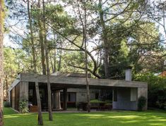 the house is surrounded by trees and grass