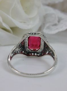 Simulated Red Ruby Sterling Silver RingLovely Rectangle Design#D148 Make heads turn and stand out with this gorgeous piece of jewelry! This Edwardian reproduction filigree ring is made from solid sterling silver and features an emerald cut high quality simulated red ruby gemstone measuring 9mm by 7mm. From the beautiful intricate floral daisy design to the inside of the band marked 925 for sterling – this ring will take your look to the next level! Look no further than this exquisite vintage-ins Red Ruby Filigree Ring, Ornate Silver Ruby Ring With Filigree Details, Silver Filigree Ruby Rings, Victorian Style Silver Ruby Ring Hallmarked, Victorian Red Ruby Ring In Sterling Silver, Ruby Gemstone, Edwardian Fashion, Filigree Ring, Engraved Items