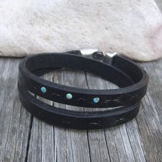 Made from top quality vegetable tanned leather.Hand painted and stamped leather wrap around bracelet. It is embellished with natural Tibetan Turquoise cabochons.Bangle is 1 cm wide and with zamak clasp closure.Please measure carefully your wrist and select the most preferable size!If you need a diferent size, please let me know after purchase in "note for seller".Please visit to my another shop:https://www.etsy.com/shop/JeansBelt?ref=hdr_shop_menu************************************************* Rustic Turquoise Leather Bracelet, Southwestern Leather Bracelet For Festival, Western Style Turquoise Leather Bracelets, Adjustable Western Leather Bracelet, Rustic Leather Concho Bracelets, Adjustable Southwestern Hand-tooled Bracelets, Western Style Hand Tooled Leather Bracelets, Rustic Hand Tooled Adjustable Bracelets, Rustic Hand Tooled Adjustable Leather Bracelet