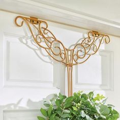 a vase filled with flowers sitting on top of a door sill next to a window