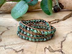 This pretty handmade wrap bracelet is made with 6 mm African turquoise stones. The green tones of this earthy bracelet are so vibrant.  It wraps 2-3 times with 3 knots for adjustment. It is on a vegan cord so is animal friendly as with all of my bracelets. One of my favourites. The variation in grey is labradorite. The variation in spots of black and beige is Dalmatian jasper.  African Turquoise is a stone that brings good luck, protection, and love to its owner. Some people believe that African Healing Turquoise Wrap Bracelet With Gemstone Beads, Spiritual Green Wrap Bracelet For Festival, Turquoise Spiritual Wrap Bracelet With Round Beads, Spiritual Turquoise Wrap Bracelet With Round Beads, Bohemian Wrap Bracelet With Round Beads For Meditation, Handmade Wrap Bracelet With Round Beads For Healing, Green Wrap Bracelet With Round Beads For Festival, Green Bohemian Wrap Bracelet With Round Beads, Bohemian Green Wrap Bracelet With Round Beads