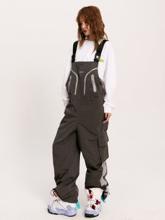 The Solaris Technical Overalls feature a wind + water-resistant nylon blend construction in a loose fit. Logo print and trim detail to the bib alongside concealed zip closure pockets. Buckle embellished shoulder straps with an adjustable waist buckle and belt loops. Cargo pockets to the legs with hardware drawcord cuffs. Rubberized logo patch to the back finished off with signature GRKC garment labels. Wind + Water Resistant Bib Overalls Buckle Shoulder Straps Cargo Pockets No Restocks Unisex Mo Cyberpunk Overalls, Overalls Reference, Subtle Poses, Mechanic Outfit, Mechanic Clothes, Cargo Overalls, Punk Character, Tech Outfit, Work Overalls