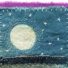 a close up of a piece of cloth with stars and moon in the sky on it