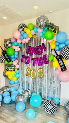 balloons and streamers decorate the entrance to a party