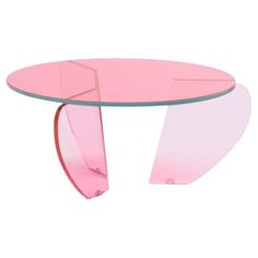 a pink glass table with curved legs and an oval shaped design on the top, against a white background