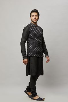 Cotton Linen blended kurta with contrast thread embroidered vest plus contrasting churidar. The cotton-linen blend makes it one of our lightest and most breathable kurtas. Crafted with a collar neckline, full sleeves, and front button closure. Occasion: Can be worn to events like Sangeet, Mehendi, & Wedding WASH CARE INSTRUCTIONS - Please Dry clean only when it is applicable. Slight color variation is possible due to digital photography. Cotton Nehru Jacket With Cutdana In Straight Kurta Style, Sleeveless Cotton Kurta For Eid, Transitional Sleeveless Cotton Kurta, Sleeveless Cotton Kurta, Traditional Black Cotton Nehru Jacket, Mehendi Wedding, Embroidered Vest, Vest Set, Mens Kurta