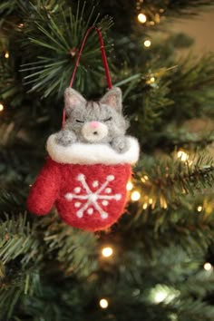 a cat ornament hanging from a christmas tree