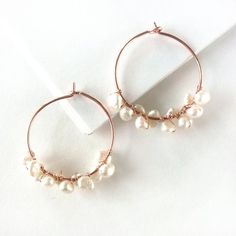 Pretty pearls and trendy rose gold are the perfect partners in these bohemian beauties!Handwrapped from genuine freshwater pearls and rose gold-filled wire. Earrings measure 1 inch/2.5 cm across.Giving as a gift? Gift wrap available here:https://www.etsy.com/listing/157310249/gift-wrap-add-on-to-any-stuff-and?ref=shop_home_feat_3 Gold Bar Earrings Studs, Ruby Earrings Studs, Gold Bar Earrings, Hammered Hoop Earrings, Gold Jewelry Sets, Bar Stud Earrings, Little Cat, Pearl Hoop Earrings, My Pinterest