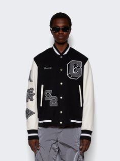 "Find GIVENCHY Varsity Jacket on Editorialist. Classic fit Sleeves in grained calfskin leather with embroidered patches on the right sleeve G, 52 patches and small GIVENCHY signature embroidered on the front4G embroidered patch on the back Ribbed elasticated knit collar, cuffs and hem with contrasting stripes Snap closure Two side pockets with contrasted piping Dimensions: Model is 6'1\"/185cm and is wearing a size EU48 Composition: 80% Wool, 20% Polyamide Care: Care according to label" Clothing Brand Ideas, Care Care, Brand Ideas, Embroidered Patch, Knit Collar, Embroidered Patches, Snap Closure, Givenchy, Varsity Jacket