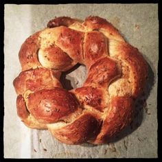 a freshly baked bread is sitting on a piece of wax paper