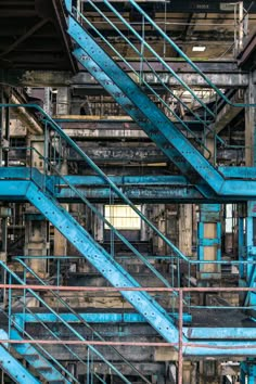 an industrial area with blue metal stairs and pipes