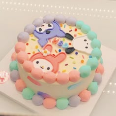 a birthday cake decorated with colorful frosting and decorations