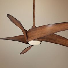 a ceiling fan with wooden blades hanging from the ceiling