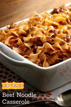 a casserole dish with cheese and ground beef in it sitting on a table