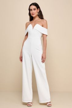 The Lulus My Favorite Night Ivory Off-the-Shoulder Jumpsuit will be your new go-to for an impressive night out look! Stretchy crepe knit fabric shapes a notched, off-the-shoulder neckline (with internal V-bar support and hidden no-slip strips) and a darted bodice with an elegant overlay that flows into short sleeves. High, fitted waist sits atop wide pant legs that fall to full-length hems. Hidden back zipper/clasp. Fit: This garment fits true to size. Length: Floor length. Size medium measures Ivory Jumpsuit, Singing On Stage, Grad Ideas, Wedding Top, Casual Wedding Dress, Adhesive Bra, Wedding Clothes, Wide Pants, Strapless Bra