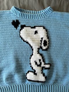 a blue sweater with a snoopy dog on it