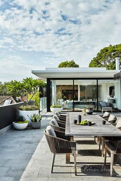 an outdoor dining area with table and chairs