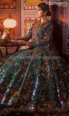 a woman in a colorful dress sitting on a chair