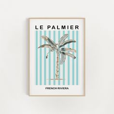 a blue and white striped poster with a palm tree in the middle, on a wall