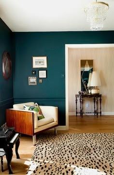 a living room with blue walls and leopard print rug