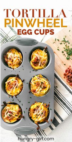 a muffin tin filled with mini pizzas on top of a wooden cutting board