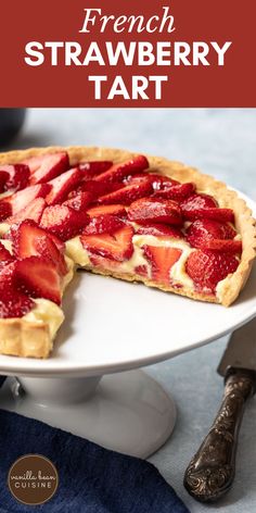 a fresh strawberry tart on a white plate