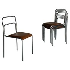 two metal chairs with brown leather seat covers