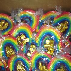 there are many bags of candy with gold decorations on the top, and one has a rainbow in it