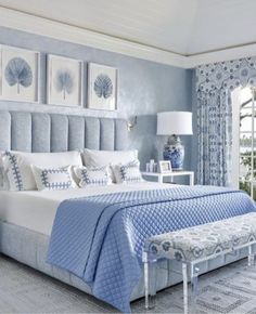 a bedroom with blue and white decor in shades of gray, light blue and white