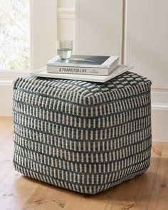 a blue and white ottoman with books on top