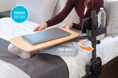 a woman sitting on top of a bed holding a tablet