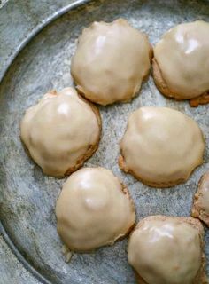 six cookies with frosting in a metal pan