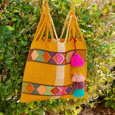 This unique bag is beautifully made on a waist loom, (Telar de Cintura) by artisans from Chiapas México.Each bag is individually handwoven with a unique colors and designs . There is not other like it! Use this reusable and eco-friendly, 100% cotton loom tote bag as a shopping bag for farmer's markets . Dress it down with a t-shirt and jeans or shorts! or to add a boho vibe to any outfit. Details: Tote measurements: 14 x 16.5 inch Handle drop: 10" Material: 100% Cotton Main color : Mustard All i Eco-friendly Multicolor Festival Bag, Multicolor Handwoven Crochet Tote Bag, Handwoven Tote Bag For Festival, Bohemian Beach Bag With Weaving For Travel, Handmade Multicolor Beach Bag For Festivals, Bohemian Multicolor Crochet Bag With Weaving, Colorful Handwoven Tote Bag, Handmade Yellow Tote Beach Bag, Artisan Multicolor Woven Shoulder Bag