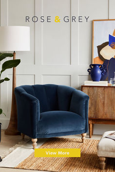 a blue velvet chair and ottoman in a living room with the words rose & grey above it