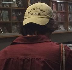 a man wearing a hat that reads fog years, not dead on the back of his head