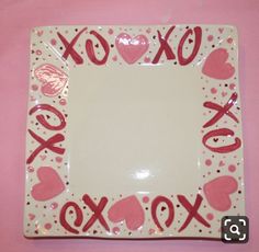 a square plate with hearts and xoxo written on the front in red ink