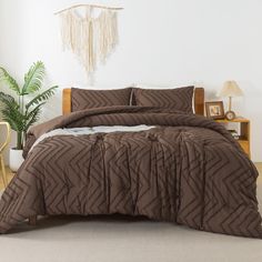 a bed in a room with a brown comforter