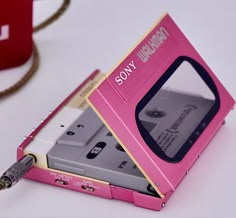 a pink floppy drive sitting on top of a white table