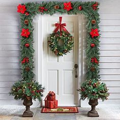 a christmas wreath with poinsettis on the front door