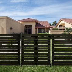 a wooden fence in front of a house