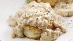 a white plate topped with meat covered in gravy