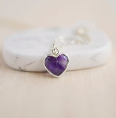 Give yourself some love or show your love for that special someone in your life with this heart necklace!Amethyst is believed to carry the energies of passion, creativity, and spirituality. It's also said to assist with temperance and sobriety, as well as inflammation.This necklace is handcrafted with a purple Amethyst faceted heart pendant. Each stone is natural and therefore contains natural inclusions or crystal formations. They are edged in 24k gold or silver electroplate. STONE SIZE: averag Spiritual Adjustable Birthstone Necklace As A Gift, Adjustable Spiritual Birthstone Necklace As A Gift, Spiritual Heart Shaped Sterling Silver Charm Necklace, Spiritual Heart-shaped Sterling Silver Charm Necklace, Spiritual Open Heart Sterling Silver Necklace, Spiritual Open Heart Necklace Gift, Amethyst Heart Charm Pendant Necklace, Amethyst Birthstone Heart Pendant Jewelry, Spiritual Sterling Silver Charm Necklaces For Valentine's Day