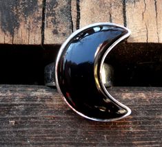 "☾Handmade, Natural Black Onyx Sterling Silver Moon Statement Rings☾ ❤︎Featured in this listing is a sterling silver, handmade, natural stone ring. This lovely ring features a beautiful, Natural Black Onyx Large Moon shaped stone. The Black Onyx Moon has been bezel set into a highly polished, Sterling Silver, sturdy setting. ❤︎Wide gradual band from 4-6mm ❤︎These large 1\" Moons in black onyx have been highly polished, with a rise of 7mm ❤︎Each ring has been hand made, so may vary slightly Stone Mystical Black Ring As Gift, Mystical Black Sterling Silver Rings, Black Adjustable Crescent Jewelry, Unique Black Jewelry With Moon Phase, Unique Black Moon Phase Jewelry, Black Crescent Celestial Jewelry, Celestial Black Crescent Jewelry, Black Sterling Silver Moon Phase Jewelry, Black Sterling Silver Jewelry With Moon Phase