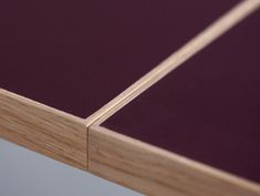 a close up view of the top of a wooden table with purple paint on it