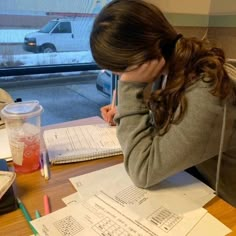 a woman sitting at a table with some papers