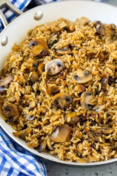 mushroom rice in a white bowl on a blue and white checkered table cloth