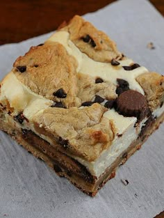 two pieces of dessert sitting on top of a piece of paper with chocolate chip cookies