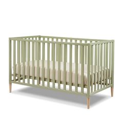 a green crib with white sheets on the bottom and side rails, in front of a white background