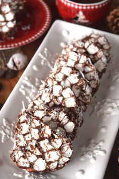 some kind of dessert on a white plate with chocolate and marshmallow toppings